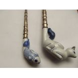 2 white metal and ceramic pipes