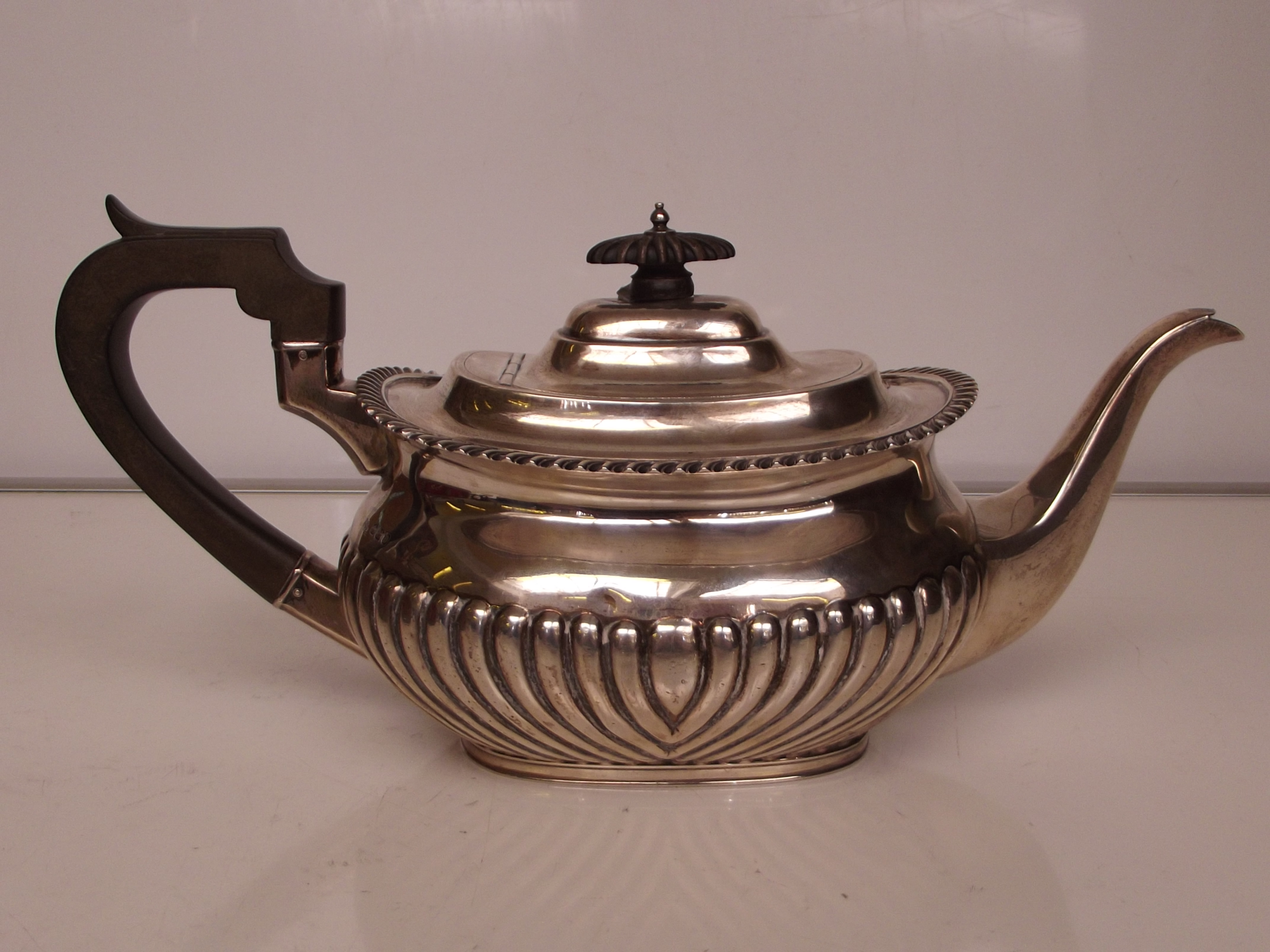 Silver teapot, half gardrooned body with rope twis