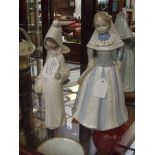 Lladro figure of a girl with one other figure