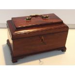 19th century mahogany tea caddy, sarcophagus form, the hinged lid with applied brass swing handle