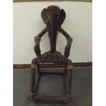 Unusual rocking chair in the form of a figure with the head of an elephant, constructed from black