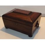 Early 19th century rosewood tea caddy, sarcophagus form with bead and reed detail and ring pull