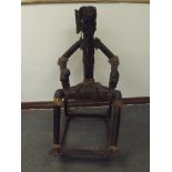 Unusual rocking chair in the form of a figure with the head of an elephant, constructed from black