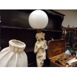 Figural table lamp with globe shade