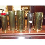 Four brass shell cases together with a plated exam