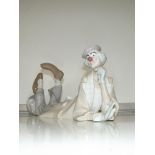 A large Lladro figure of a clown laying down 38x15