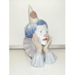 A large Lladro bust of a sad clown resting his hea