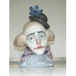 A large Lladro bust of a sad clown resting his hea