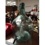 Glass carboy together with a similar example