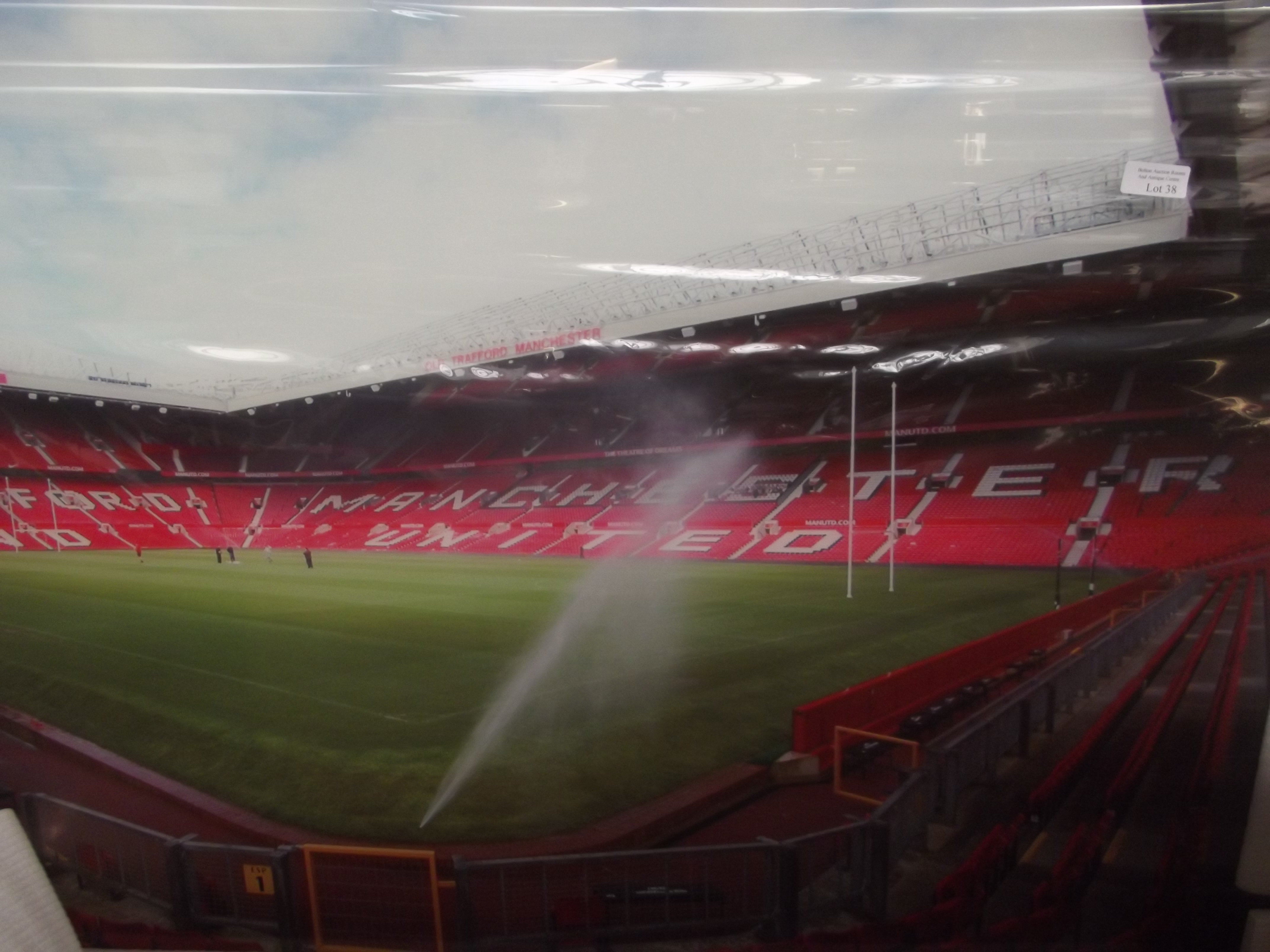 Large glass wall art depicting Old Trafford