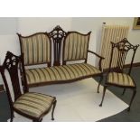 Edwardian mahogany three piece drawing room suite comprising settee and two side chairs