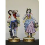 Late 19th/early 20th, pair of Continental figurines in the form of flower pickers, height 20cm