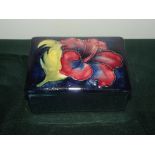 Moorcroft lidded trinket box in the Hibiscus pattern, length 9cm