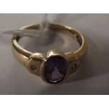 9 carat gold dress ring set with amethyst flanked