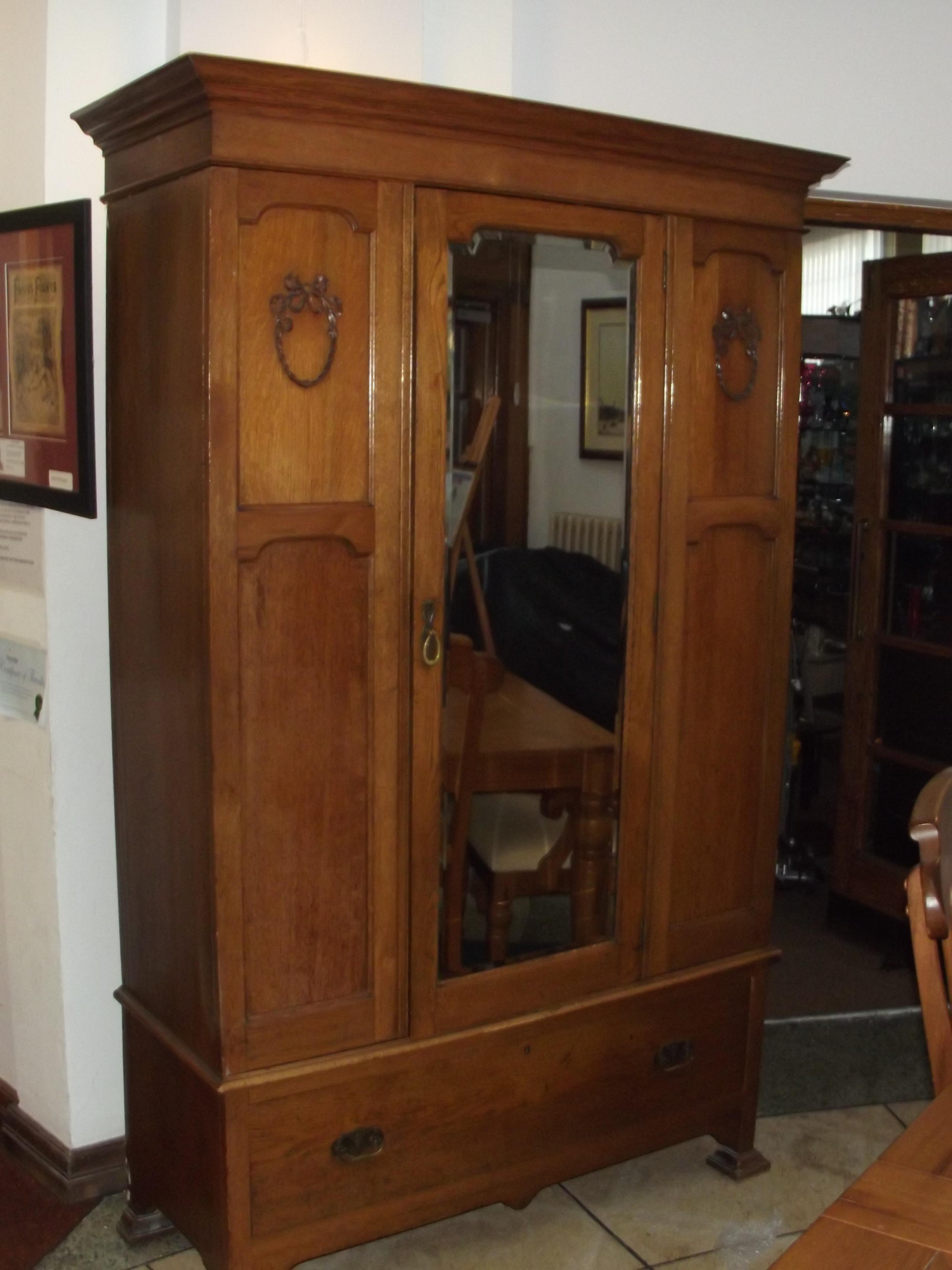 Edwardian oak mirrored wardrobe with base drawer