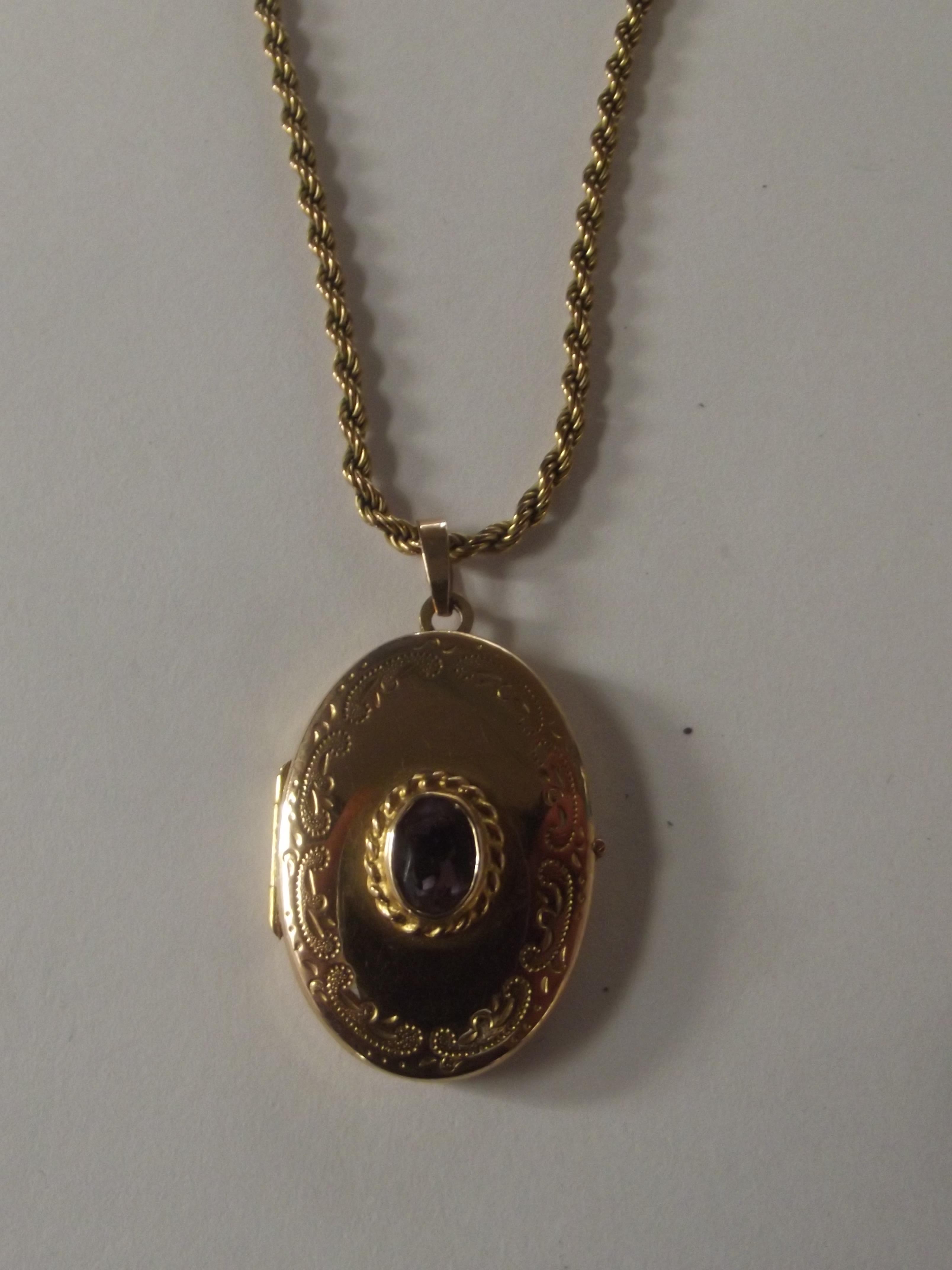 9 carat gold locket with central amethyst on a 9 c