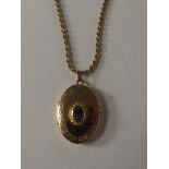 9 carat gold locket with central amethyst on a 9 c