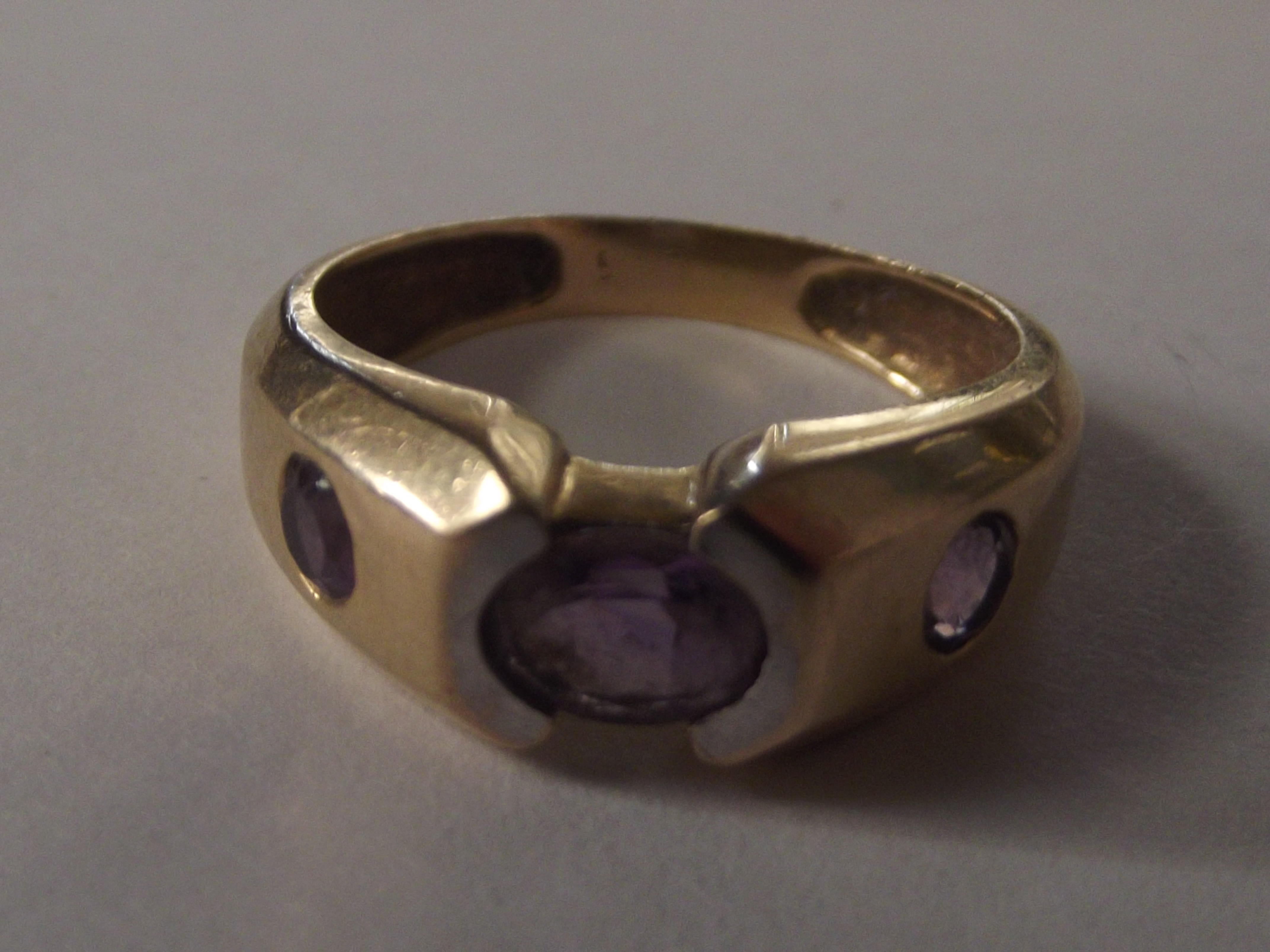 9 carat gold dress ring set with three amethyst, s