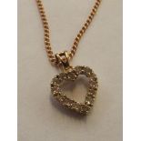 9 carat gold heart shaped pendant set with white g