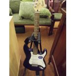Squier electric guitar with stand