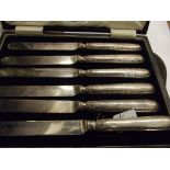 Cased set of six silver handled butter knifes