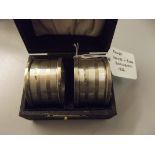 Cased pair of silver engine turned napkin rings, D