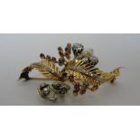 An 18ct brooch of floral form set with diamonds, pearls,