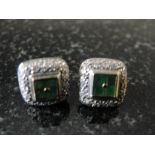 A pair of diamond and emerald earrings