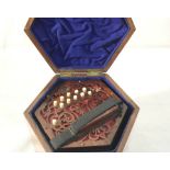 A concertina in rosewood with 10 buttons each side in mahogany case with recessed brass handle by A