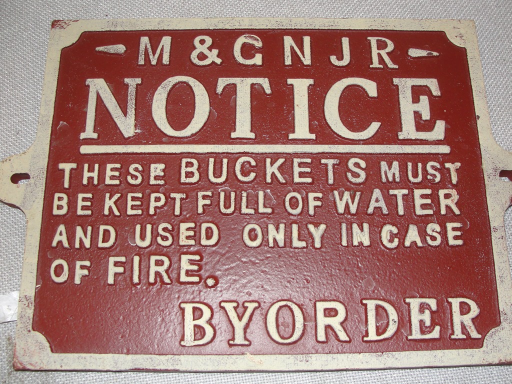 A cast-iron sign: 'Fire Bucket'
