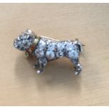 A miniature diamond and ruby set dog brooch,