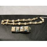 A vintage mother-of-pearl necklace;