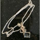 An aquamarine and diamond pendant on an 18ct white gold chain