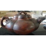 An early 20th century yixing teapot with prunus design