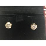 A boxed pair of large diamond studs,