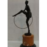 A bronze Art Deco girl with hoop on onyx socle