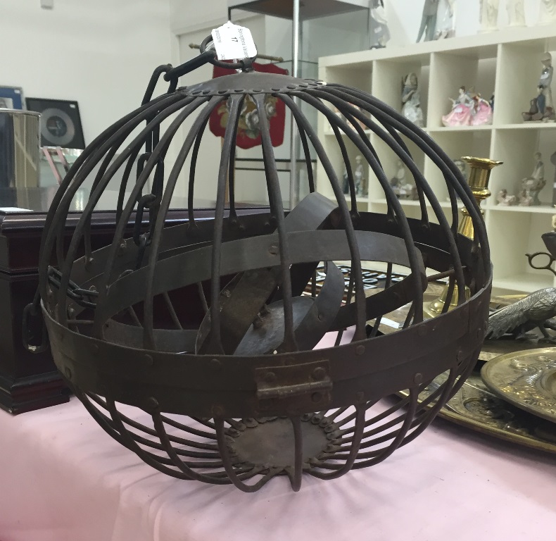 A 19th century cast metal hanging sphere enclosing a gimble mount