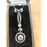 An Edwardian diamond drop pendant on chain by the Goldsmith & Silversmith Co, in fitted box,