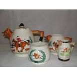 A three-piece tea set with fox and hound decoration;