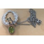 A diamond and peridot drop pendant on an 18ct chain