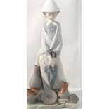 A large Lladro figurine of a girl with hands on umbrella