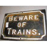 A cast-iron sign: 'Beware of Trains'