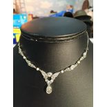 A platinum and diamond set necklace,