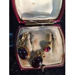 A boxed pair of double drop cabochon garnet earrings in gold mounts