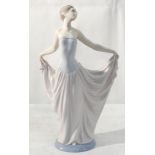 A Lladro figure of a lady holding the hem of her skirt,