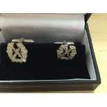 A pair of silver regimental cuff links