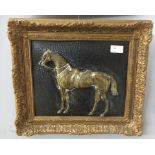 A brass relief plaque of a horse portrait