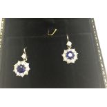 A boxed pair of diamond and sapphire cluster earrings