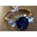 An 18ct diamond and sapphire trilogy ring