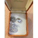 Two silver necklaces: one with a heart-shaped locket the other an "S" set with CZ`s